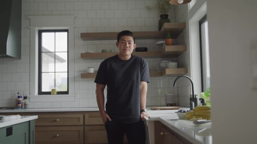 A man is leaning on the sink