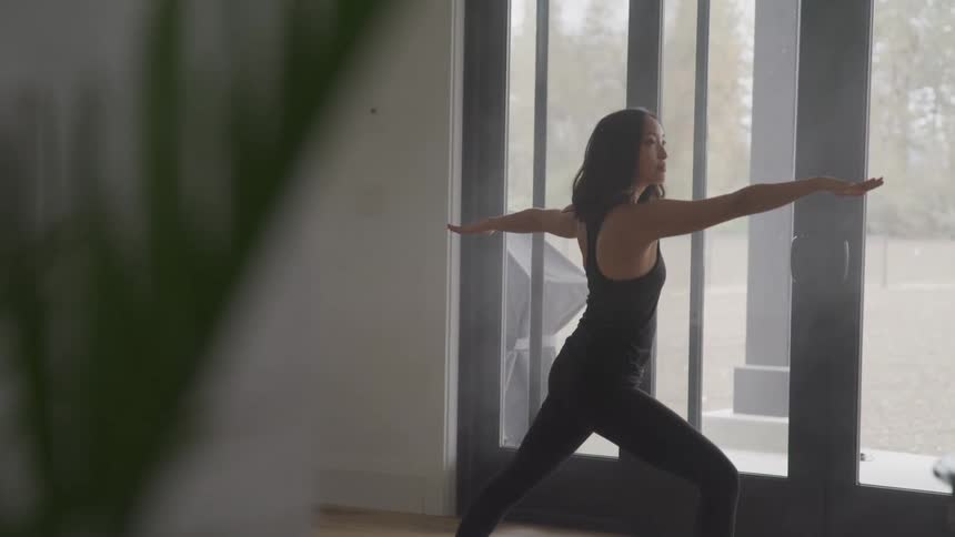 A woman practicing yoga indoors
