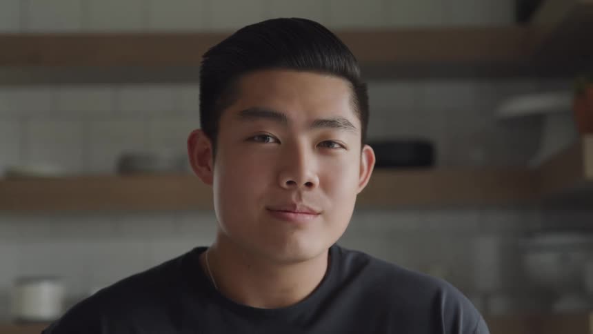 A man turns and smiles at the camera