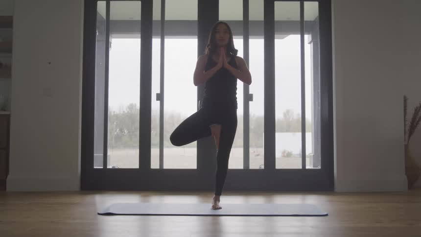 A footage of a person doing yoga indoor