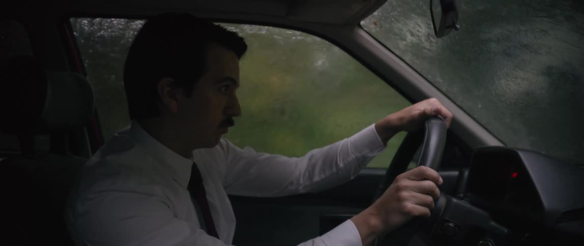 Man driving a car on a rainy day