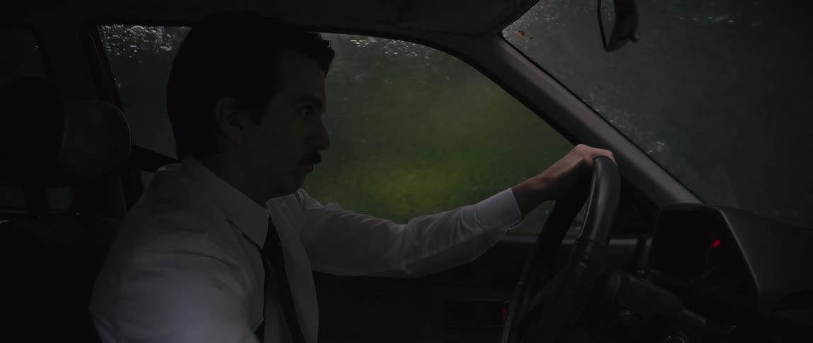 Man is operating a motor vehicle while its storming outside