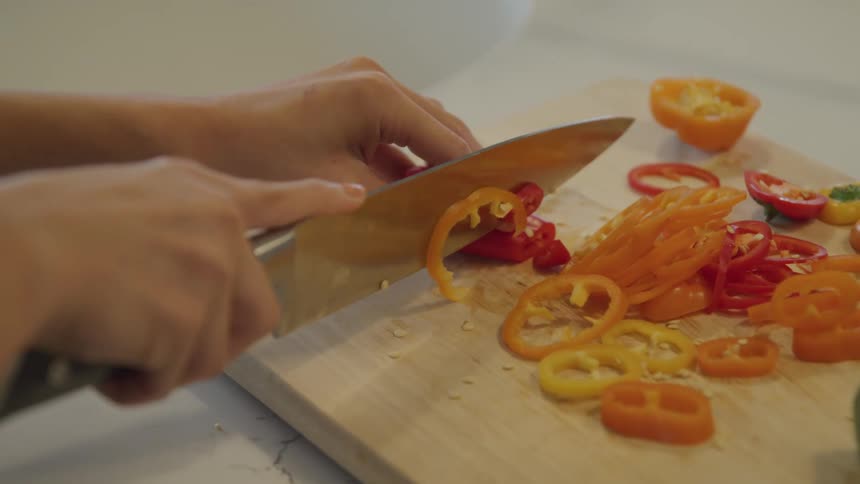 A person slices peppers