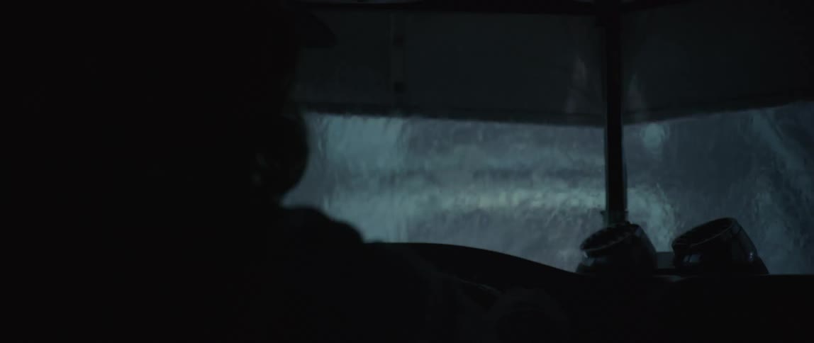 The rain pours while a car crosses the bridge