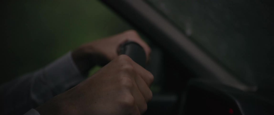A man is driving in heavy rain