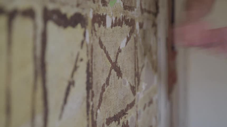 A wall is struck by a hammer