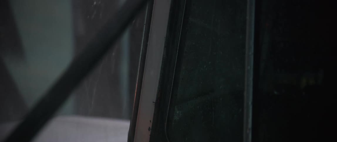 A car drivers over a bridge in the rain