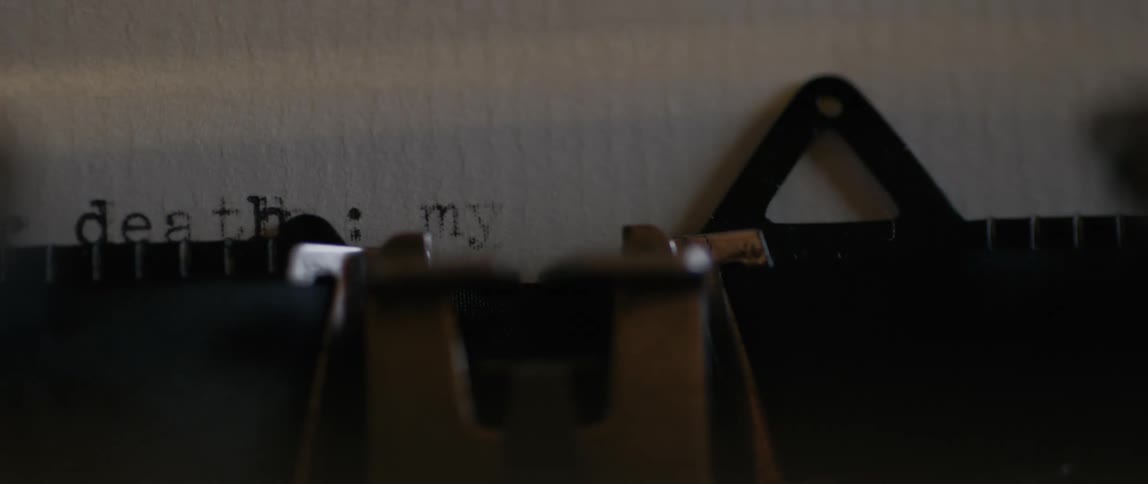 Text being typed on white paper on an old typewriter