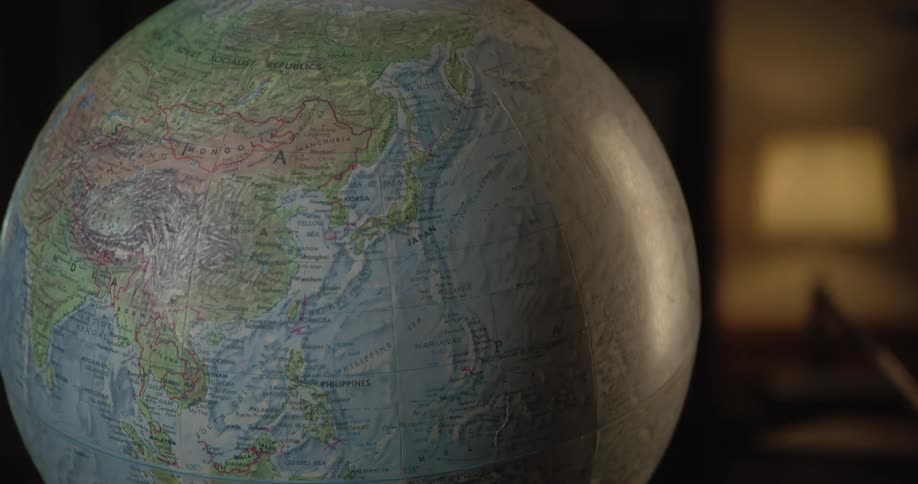 A globe is sitting in an office at night
