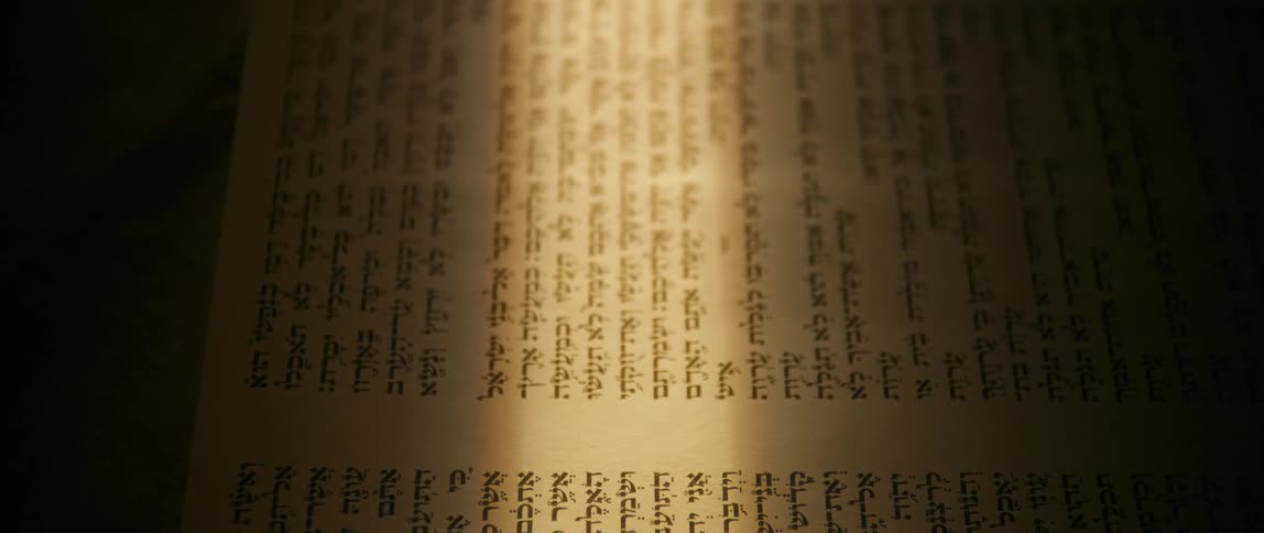 Close up of a book with scriptures and a beam of natural light