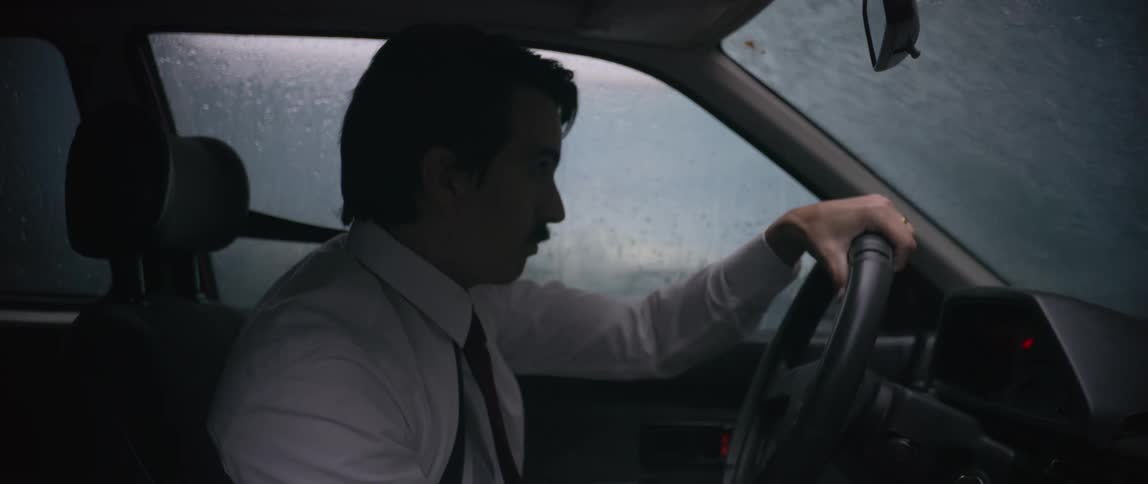 Man having some difficulty driving a vehicle in the rain
