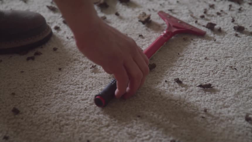 A person picks up a tool
