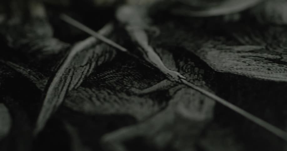 Close up of a black and white drawing of a battle between angels and demons