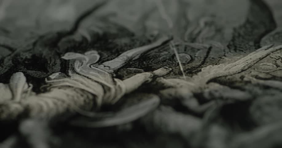 A black and white painting is on the canvas