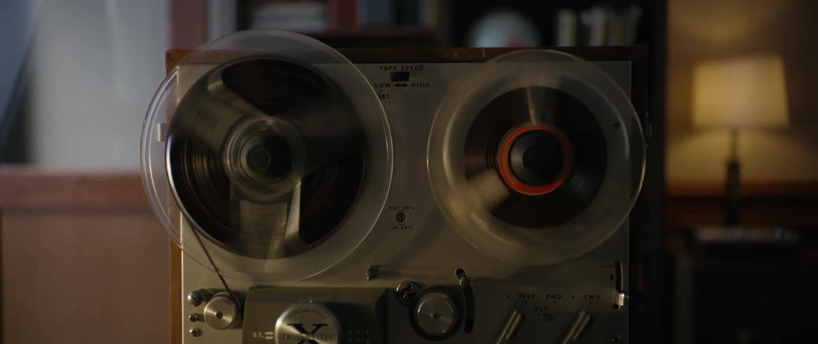 A vintage movie projector spins its wheels