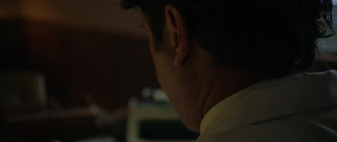 A man is sorting tapes at his desk