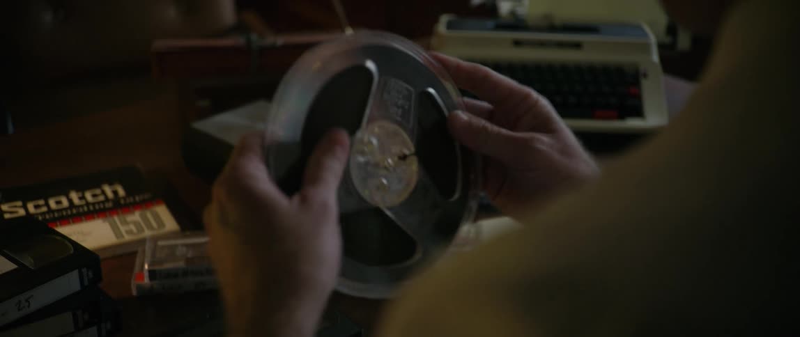 An image of a person arranging an audio tape