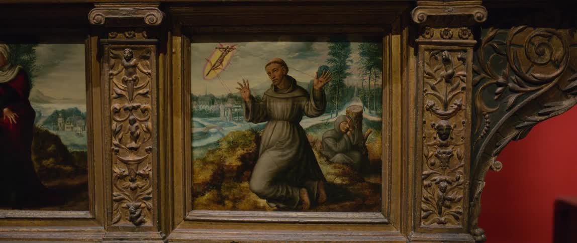 An ancient painting of a catholic monk on his knees