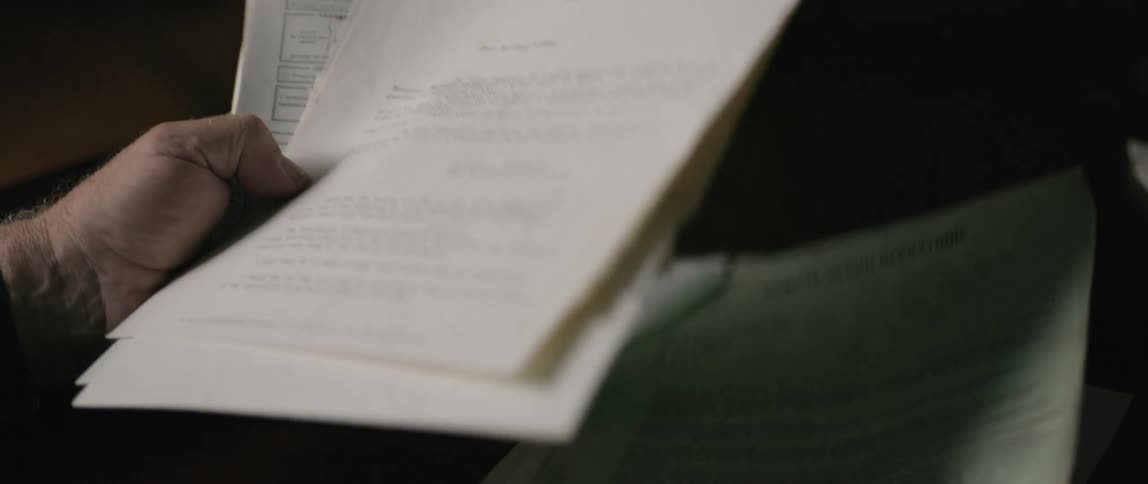 A man is flipping through documents