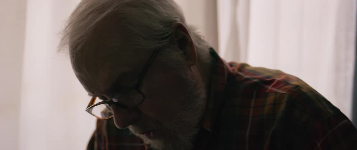 A man talks and looks down