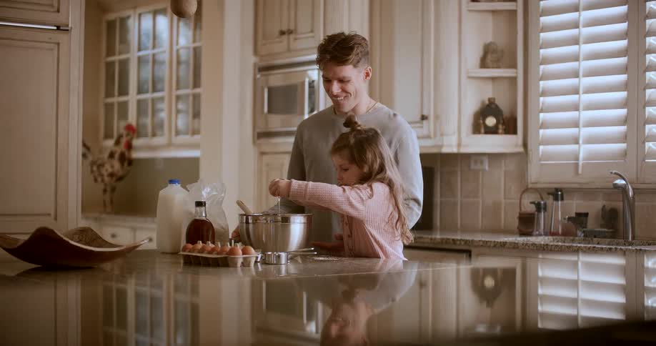 Father with his little daughter cooking
