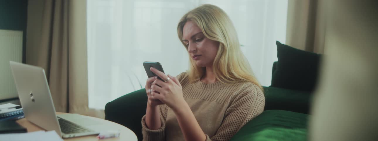 Woman sitting interacting on smartphone