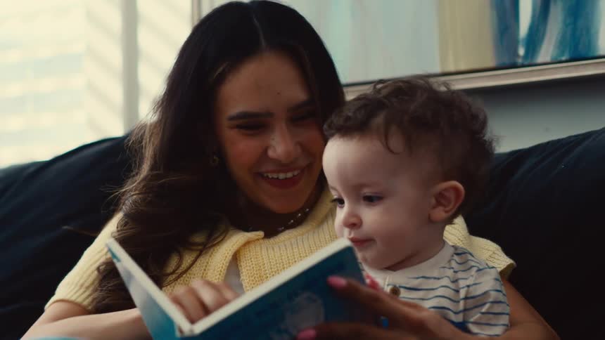 A mother is reading to her son
