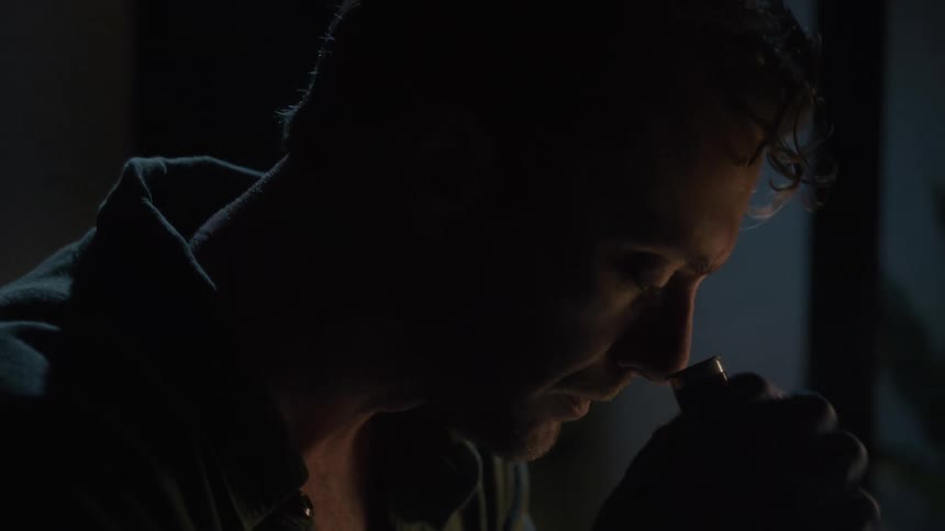 A man examines something with a microscope