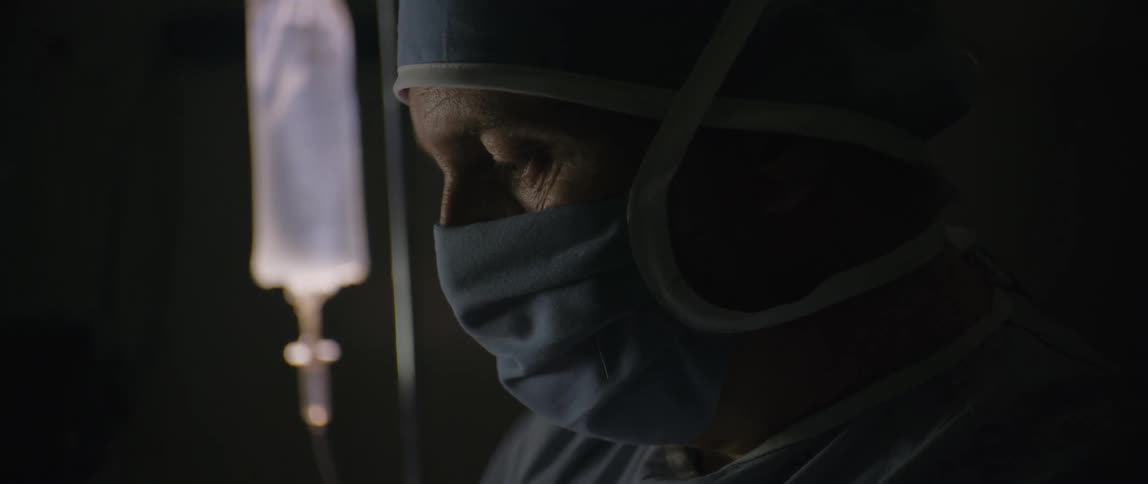 A surgeon working on a patient in the operating room