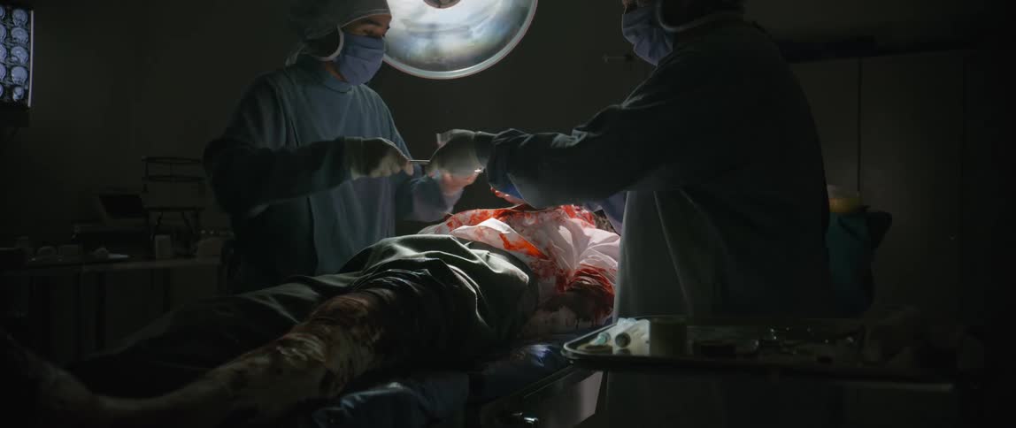 Surgeons performing operation on a patient in the theatre