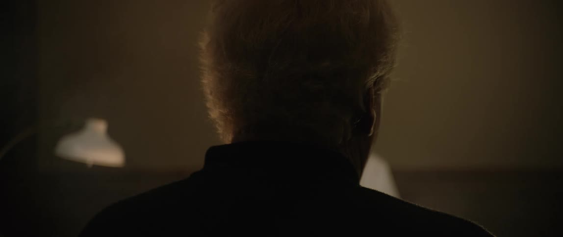 A man is in a dark room
