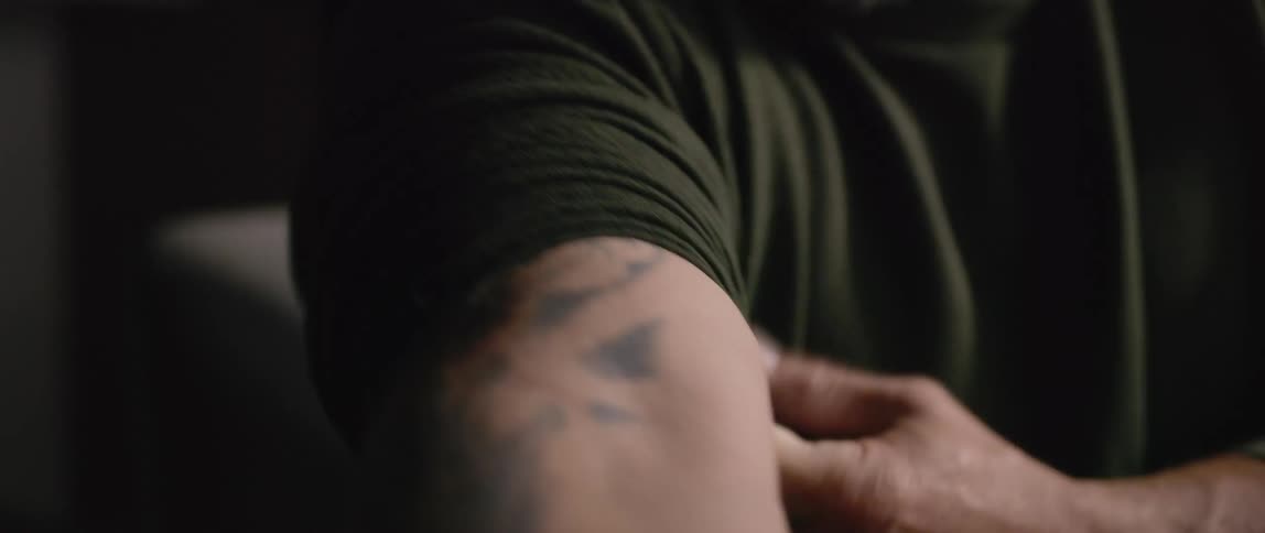 Close up of a mans tattooed arm