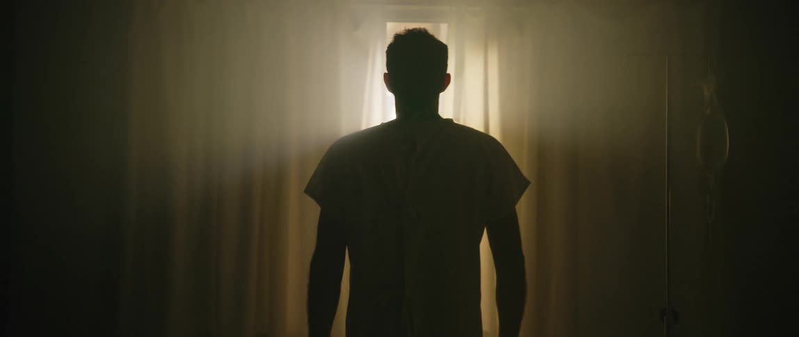 A back clip of a man standing beside the window
