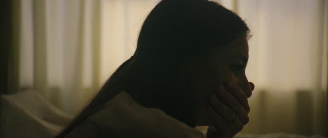A woman is talking and sobbing