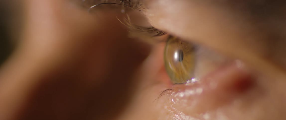 A man quickly blinks his eye