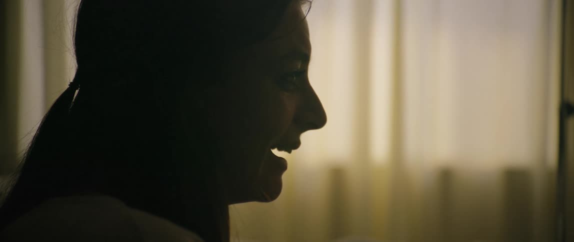 A woman is told something that makes her look shocked cover her mouth and break down crying