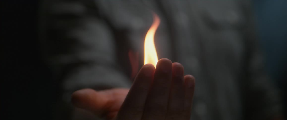 A person holding fire in their palm