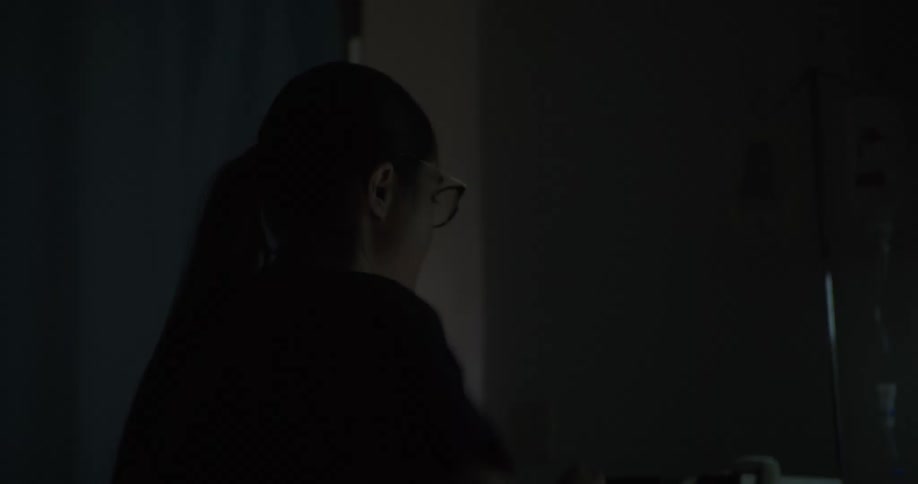 Woman tries to resuscitate a patient with a defibrillator in a hospital