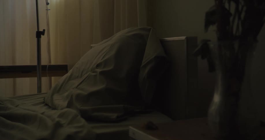 The dark hospital has an empty bed