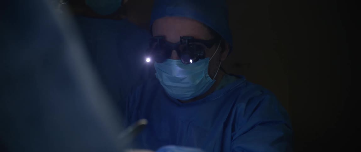 The surgeon is using different tools in the operating room