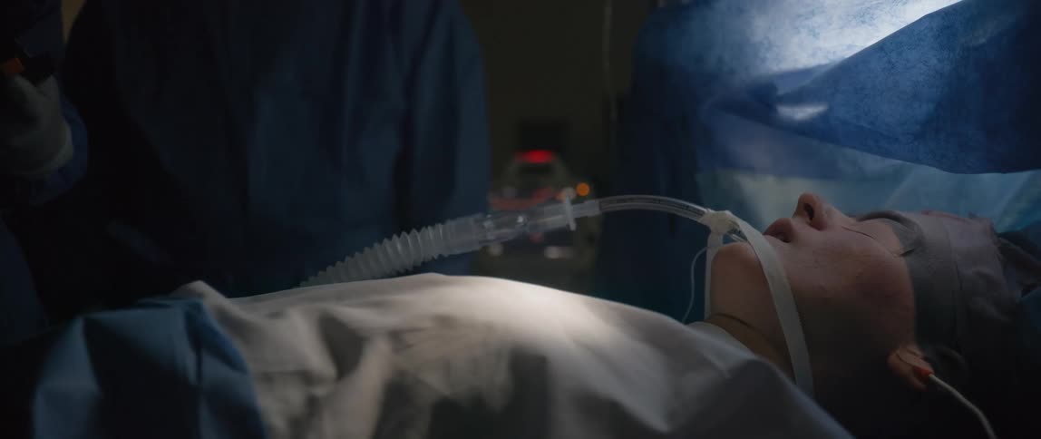 A doctor uses a defibrillator on a sick patient