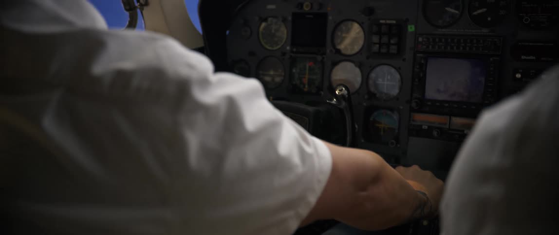 A man pushes the lever in the airplane