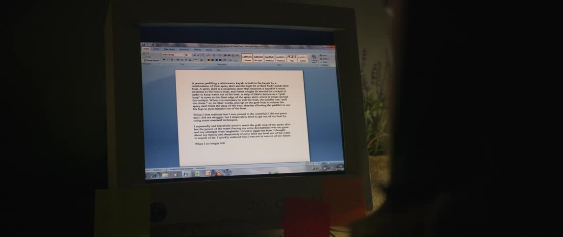 A computer has a document pulled up and text is being typed into the document