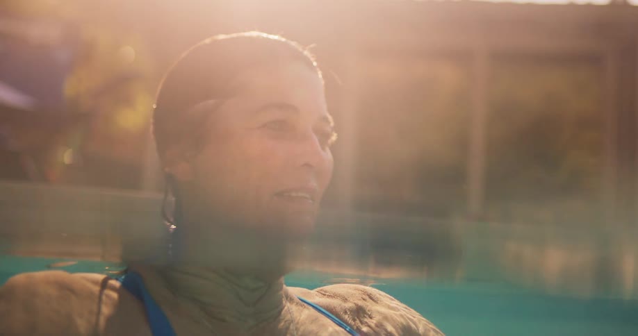 Woman floating in a pool thinking