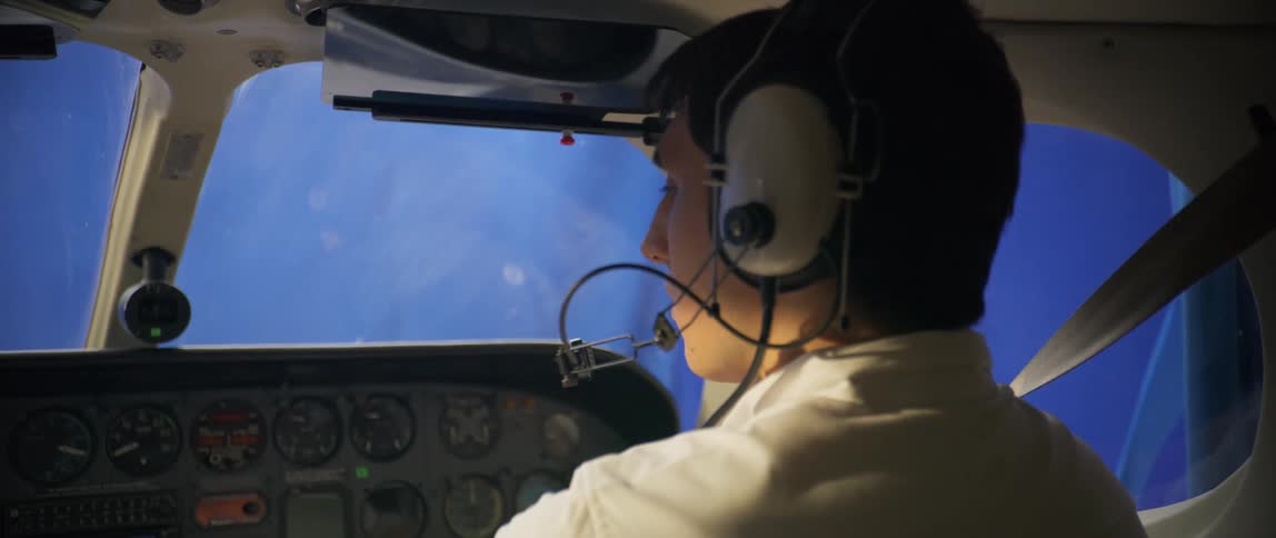 A pilot puts his headset on