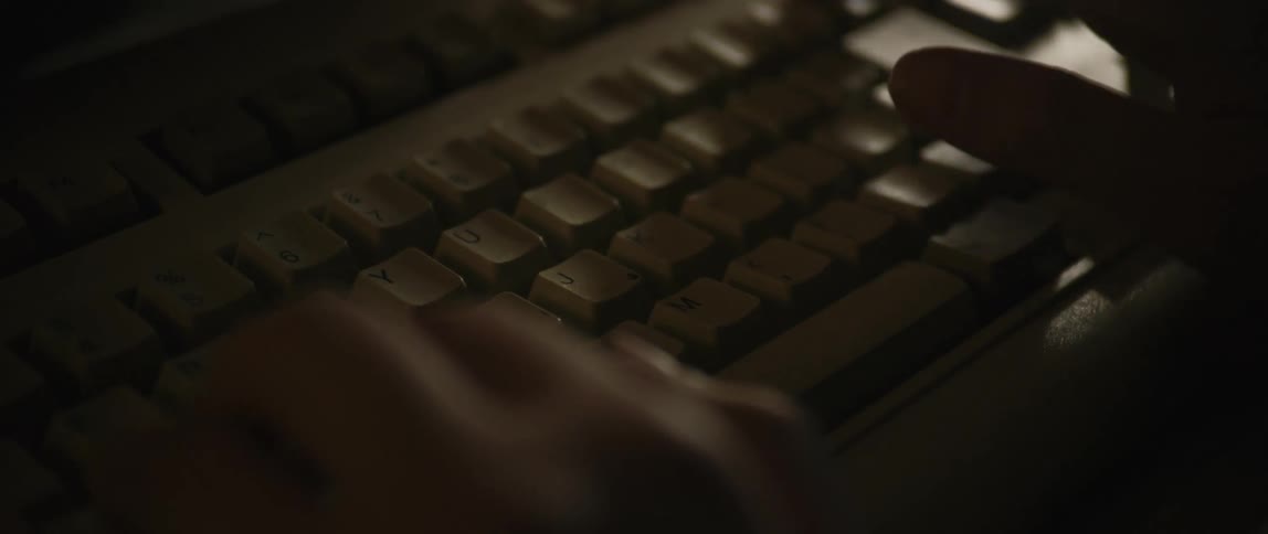 A person types on a computers keyboard