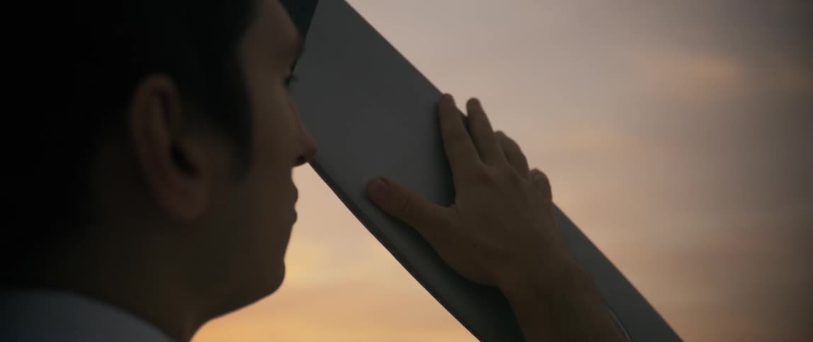 A man gently touching the propeller of an airplane