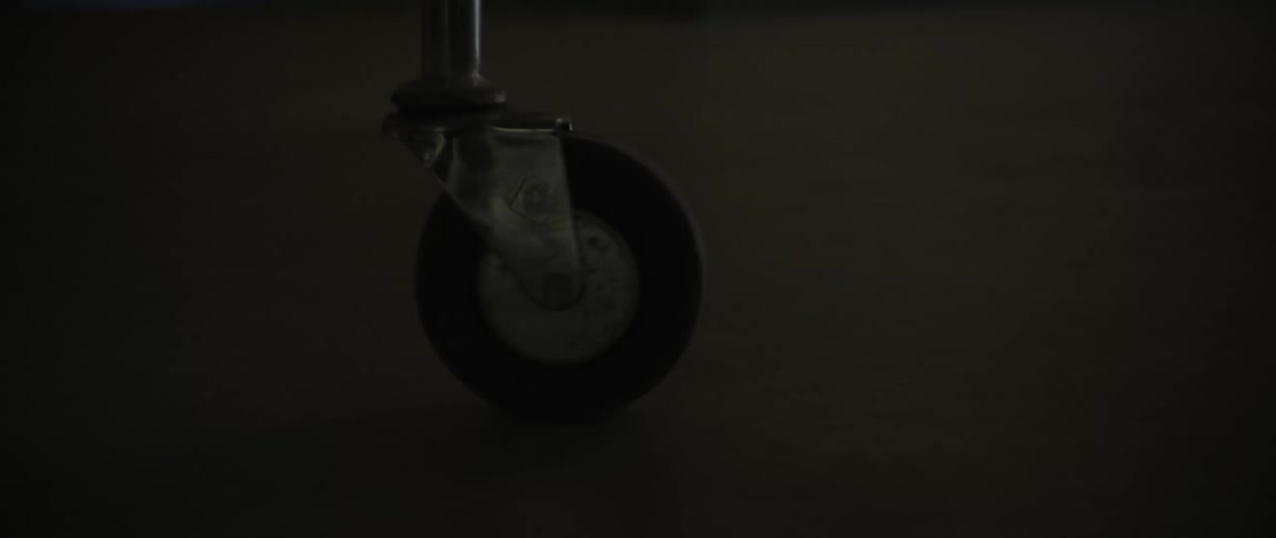 A wheel of an equipment turns as it moves along a corridor