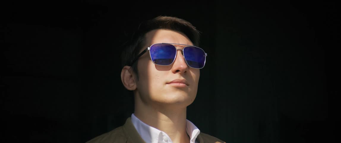 A man steps out into the sunlight