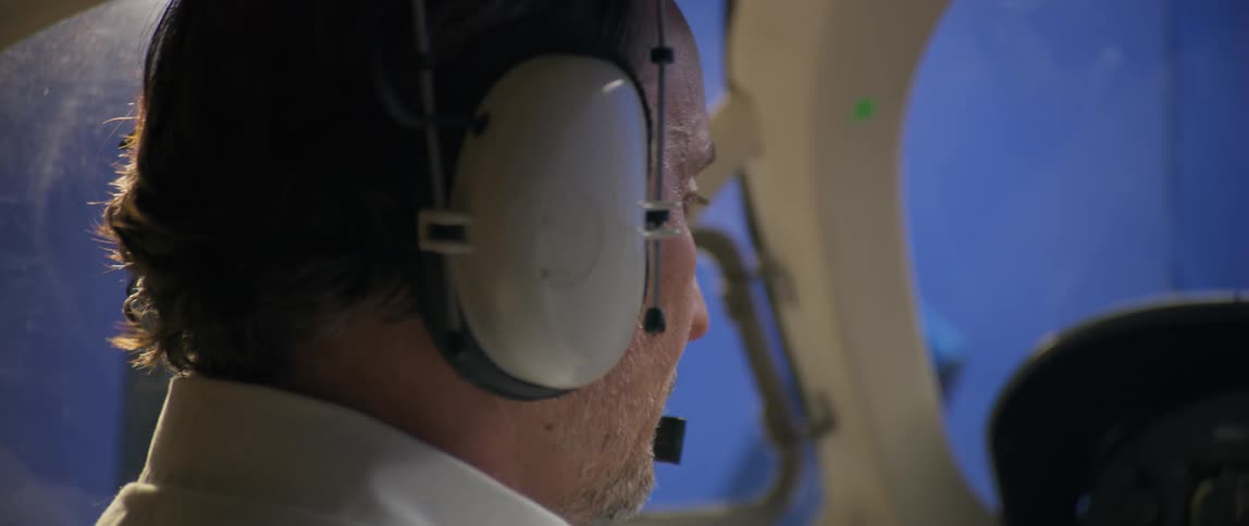 A pilot puts on a headset and begins speaking